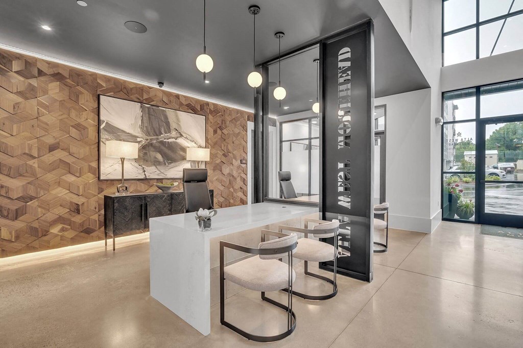 the lobby of a modern office with a reception desk and chairs