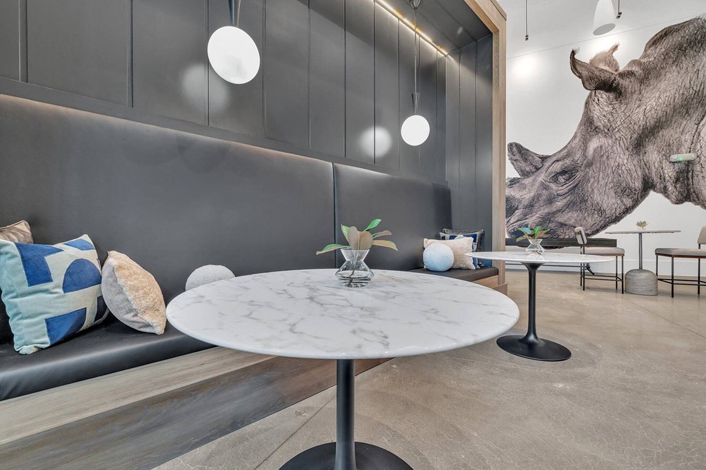 a dining room with a table and a giraffe on the wall