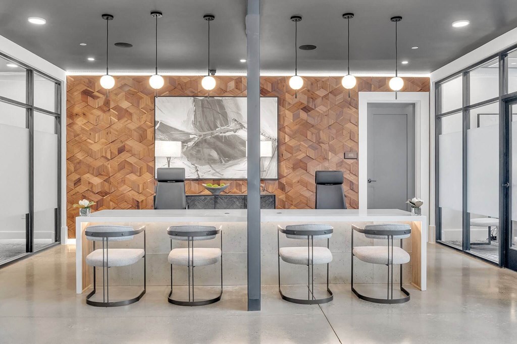 a kitchen and dining area with stools in front of a wood wall
