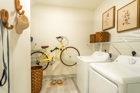 a laundry room with a bike on the wall