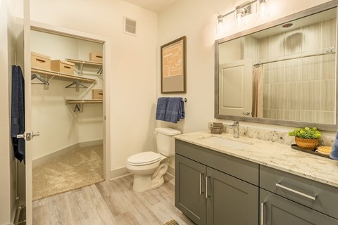 a bathroom with a toilet and a shower and a sink
