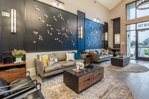 a living room with couches and a large painting on the wall