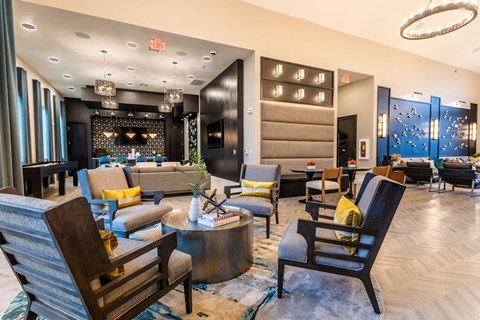 a lobby of a hotel with couches chairs and a table