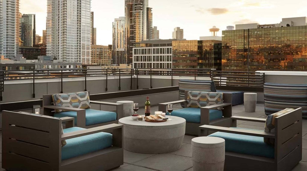 a rooftop patio with a view of the city