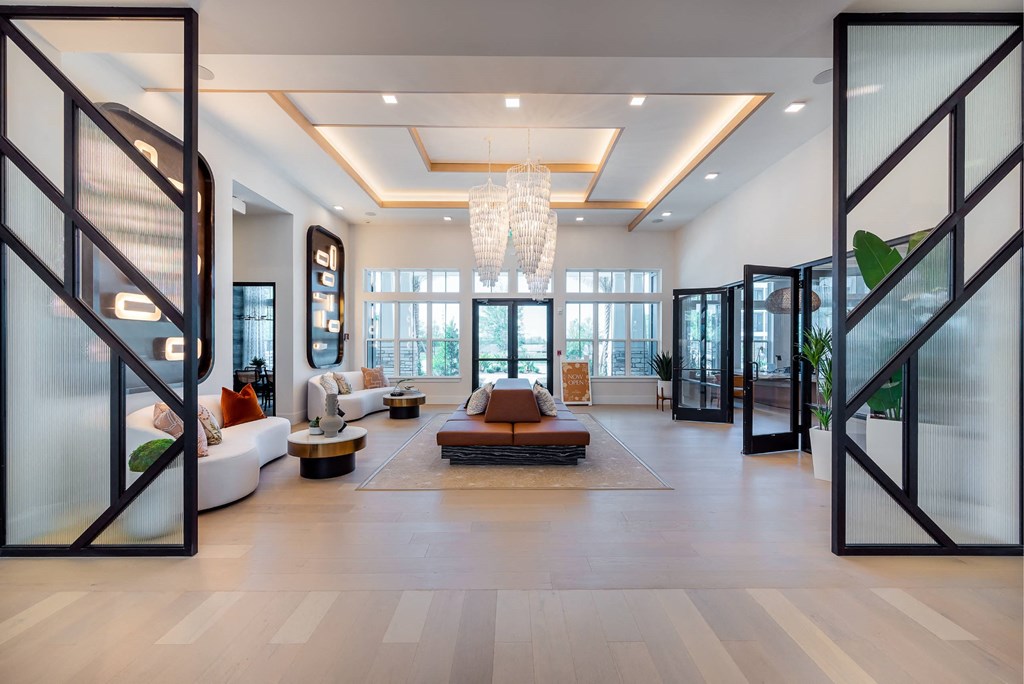 a living room with a couch and a chair and a chandelier