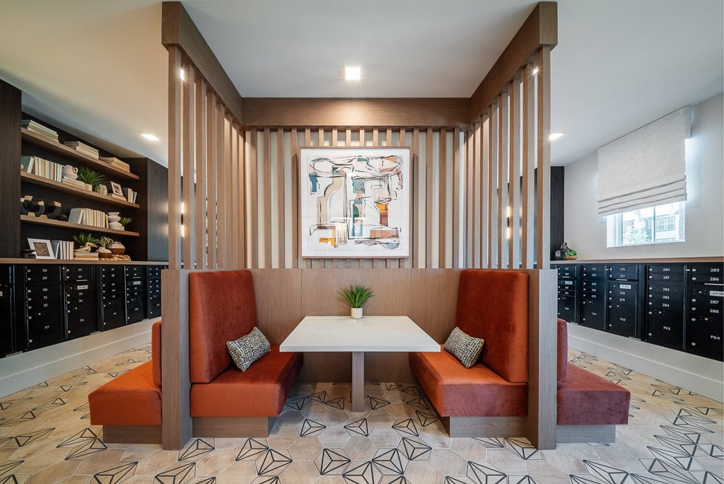 a conference room with two orange couches and a white table