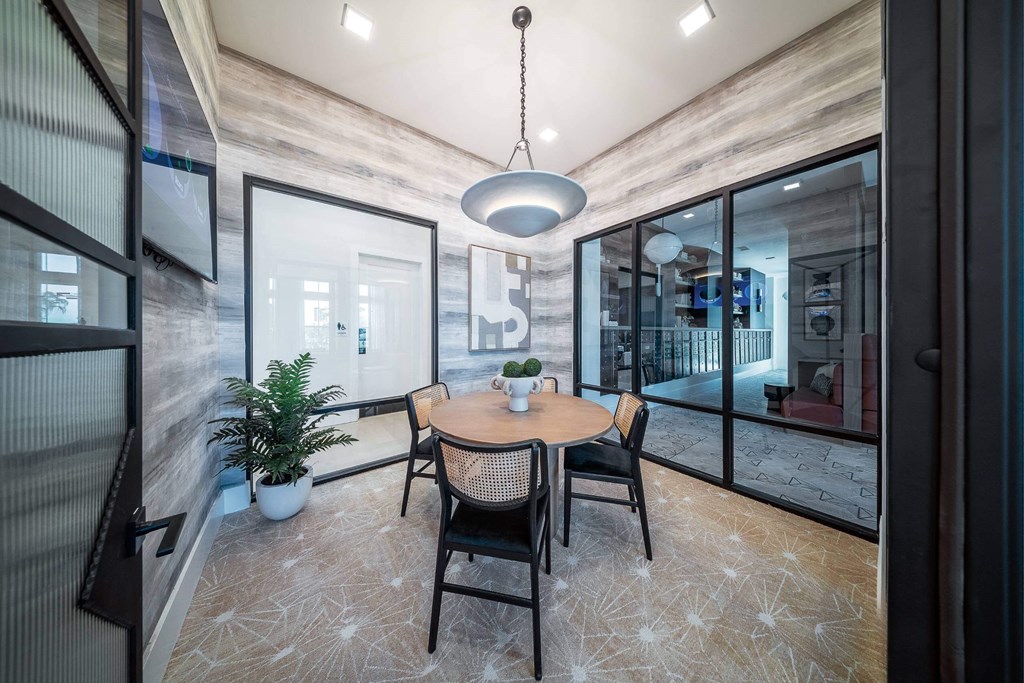 a dining room with a table and chairs