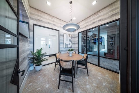 a dining room with a table and chairs