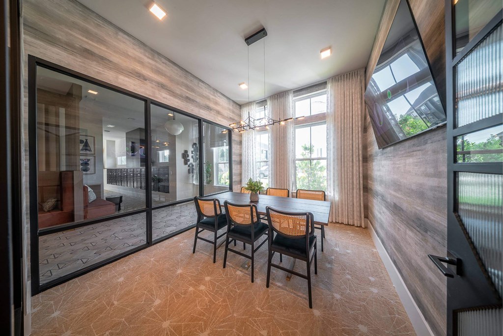 a dining room with a table and chairs and a large window