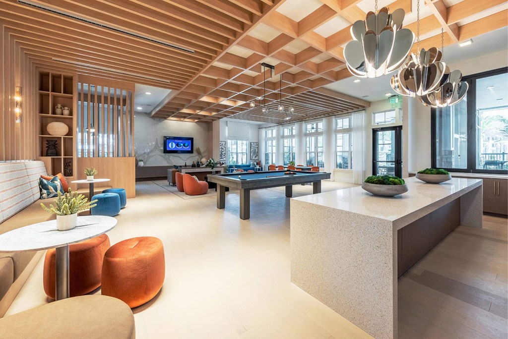 the lobby of a hotel with a pool table