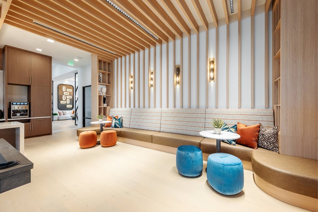 the lobby of a hotel with seating and tables