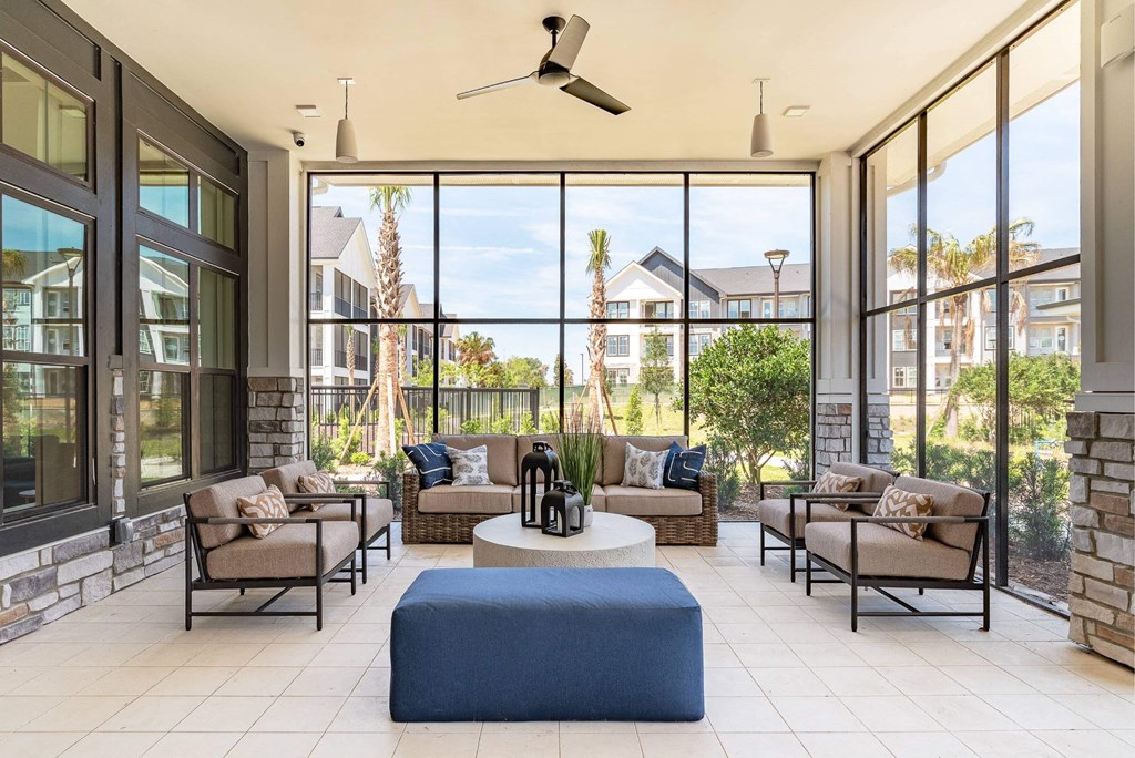 a living room with furniture and large windows