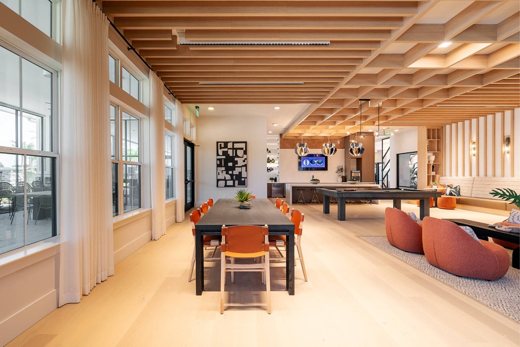 a dining room with a long table and chairs