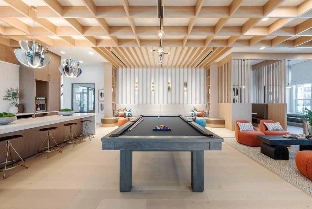 a living room with a pool table in the center of it