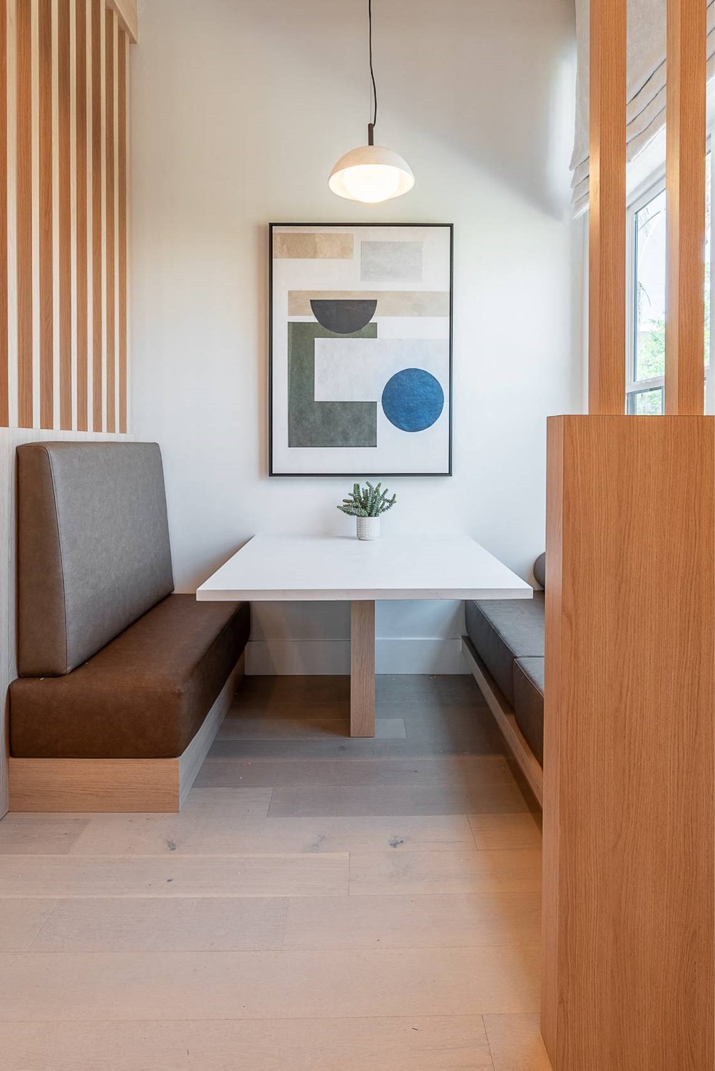 a small dining room with a white table and a chair