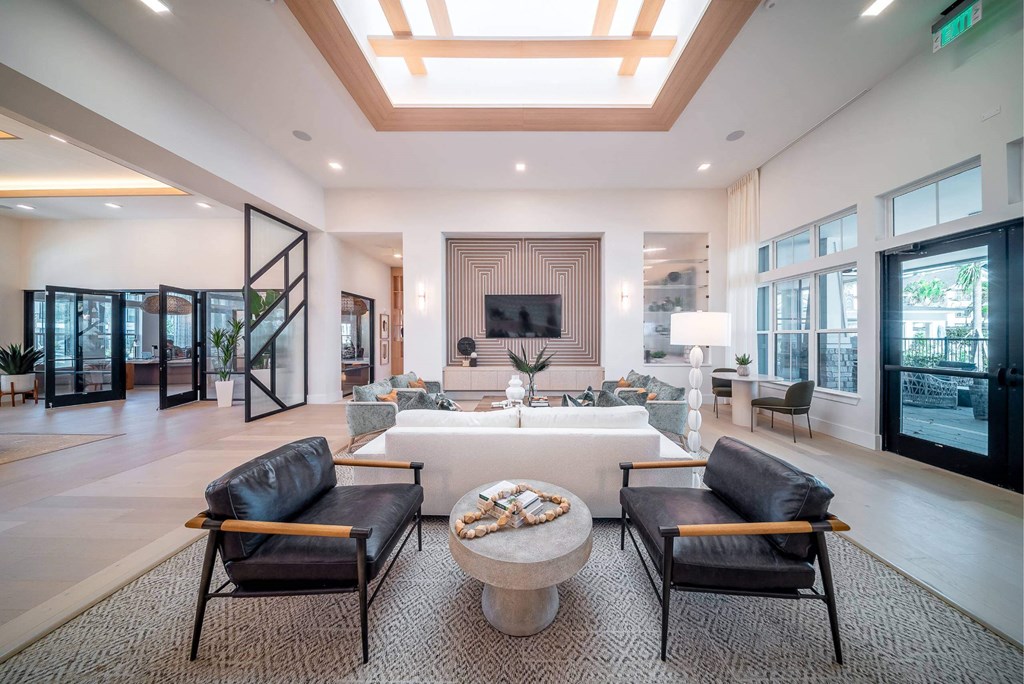 a large living room with a large white couch and chairs