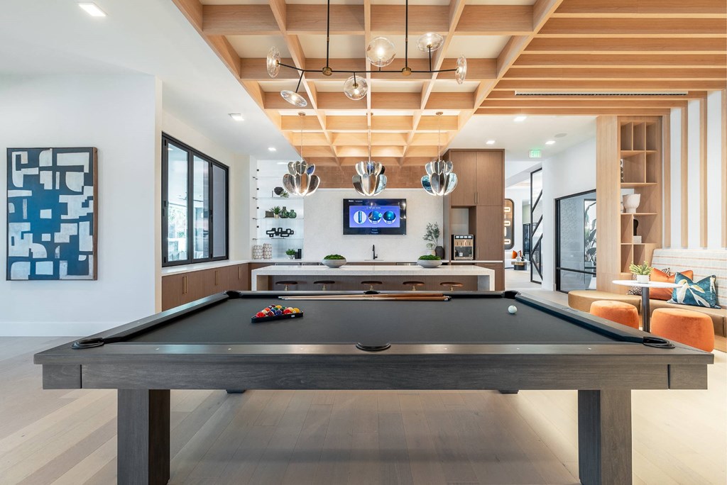 a pool table in the living room of a house with a television