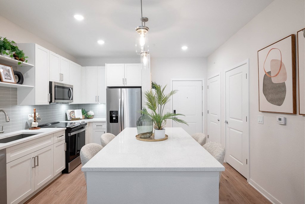 a kitchen with white cabinets and a white counter top