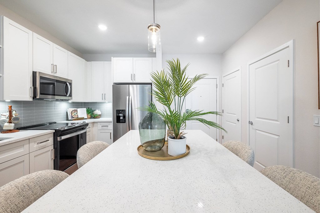 a kitchen with white cabinets and a white counter top