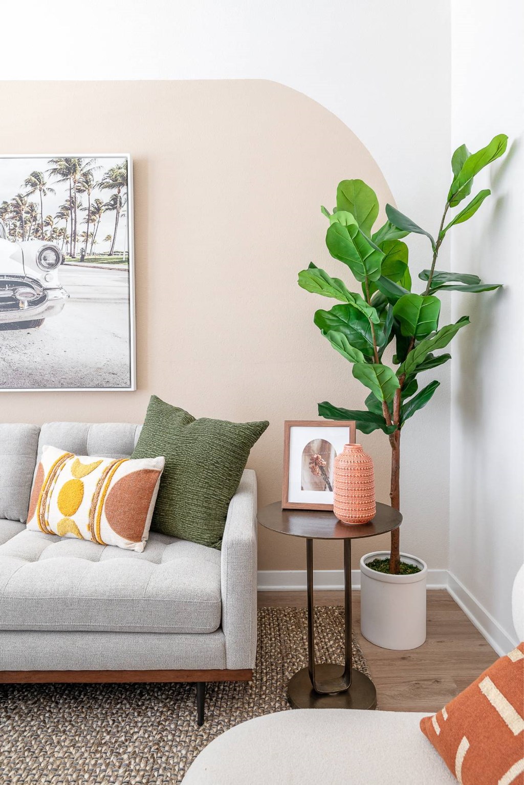 a living room with a couch and a potted plant