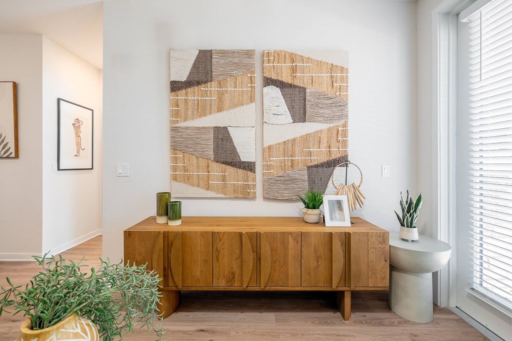 a living room with a table and a painting on the wall