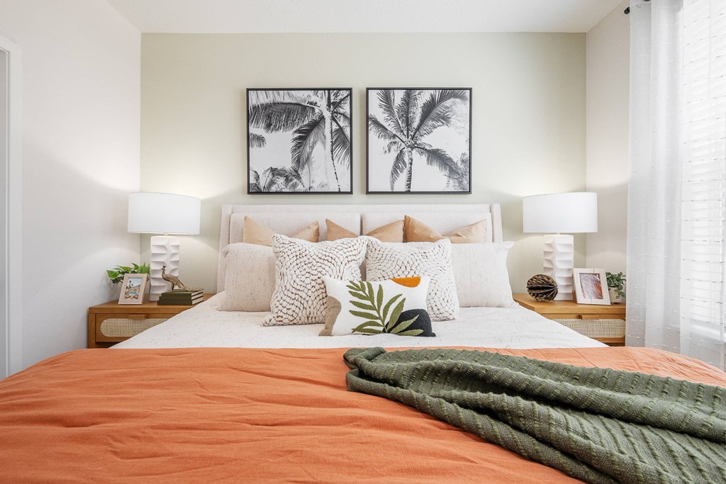 a spiral staircase with three pictures on the wall and plants on it