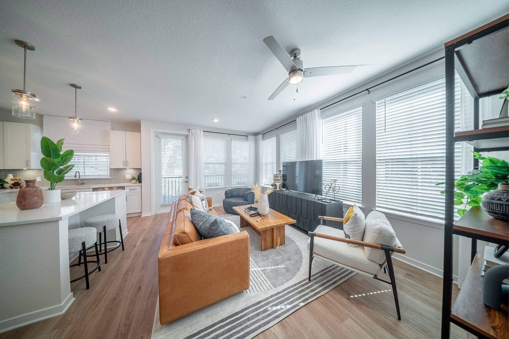 an open living room and kitchen with a ceiling fan