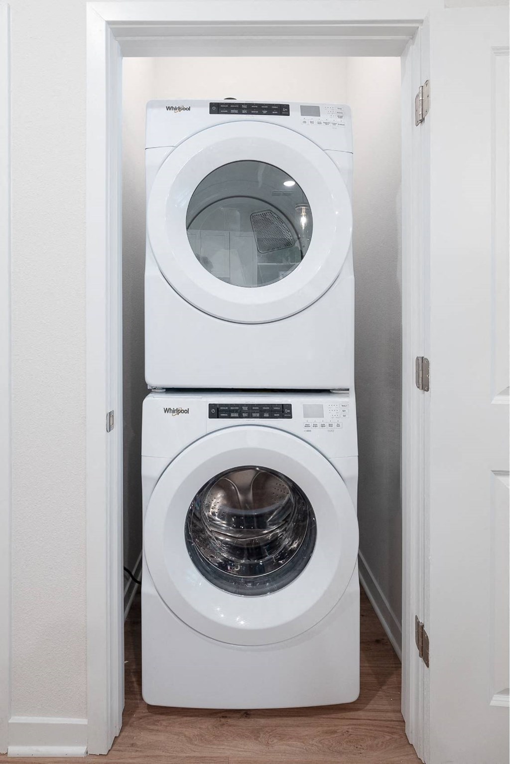 a white washer and dryer in a small laundry room