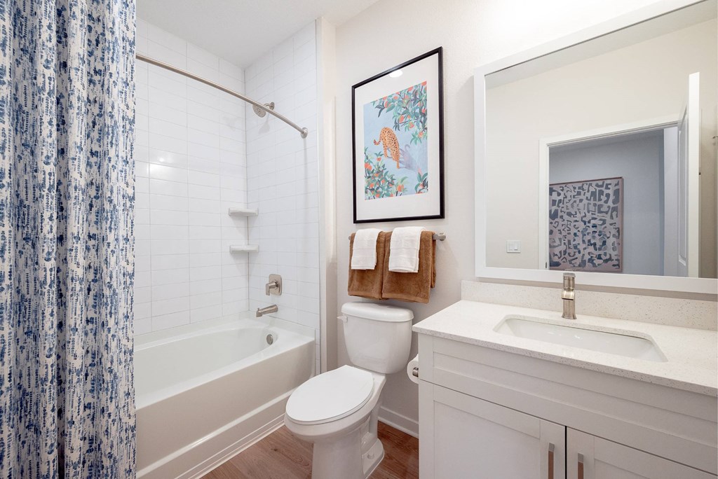 a bathroom with a toilet and a tub and a sink