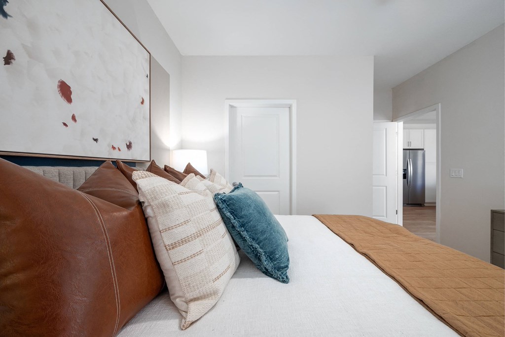 a bedroom with a large bed with pillows