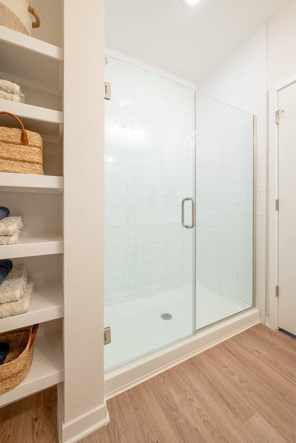 a walk in shower with a glass door in a bathroom