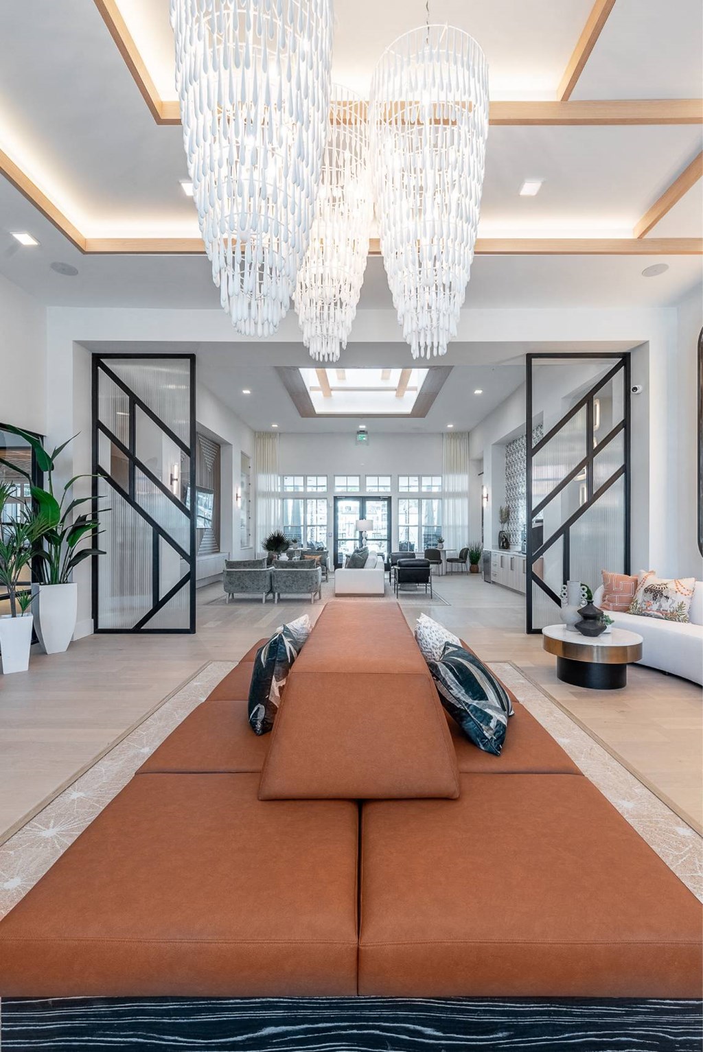the living room has chandeliers and a large rug