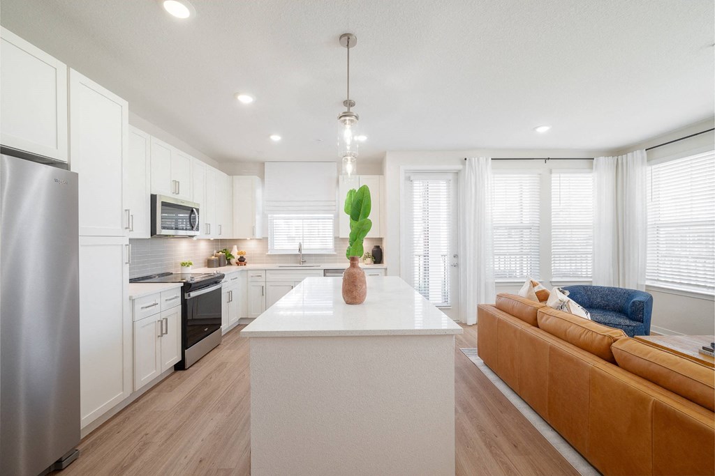 a kitchen with white cabinets and a white counter top