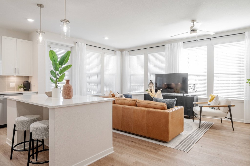a living room with a couch and a kitchen