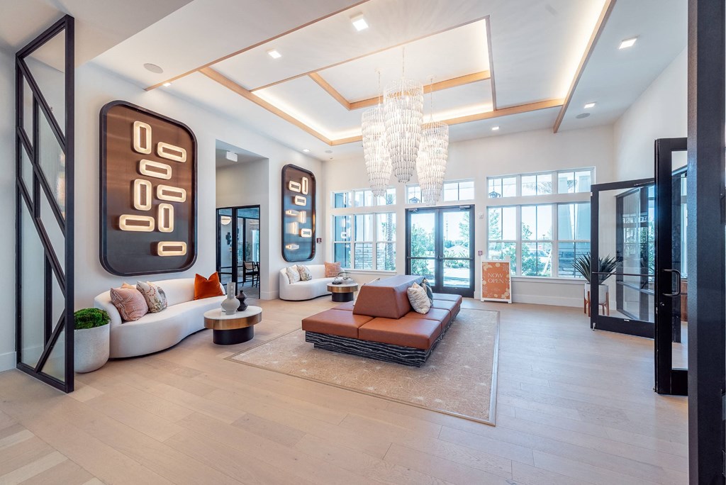 a living room with a large couch and a chandelier