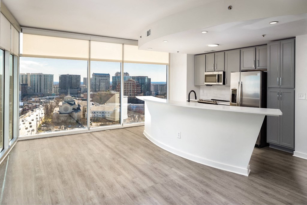 an open kitchen and living room with a view of the city
