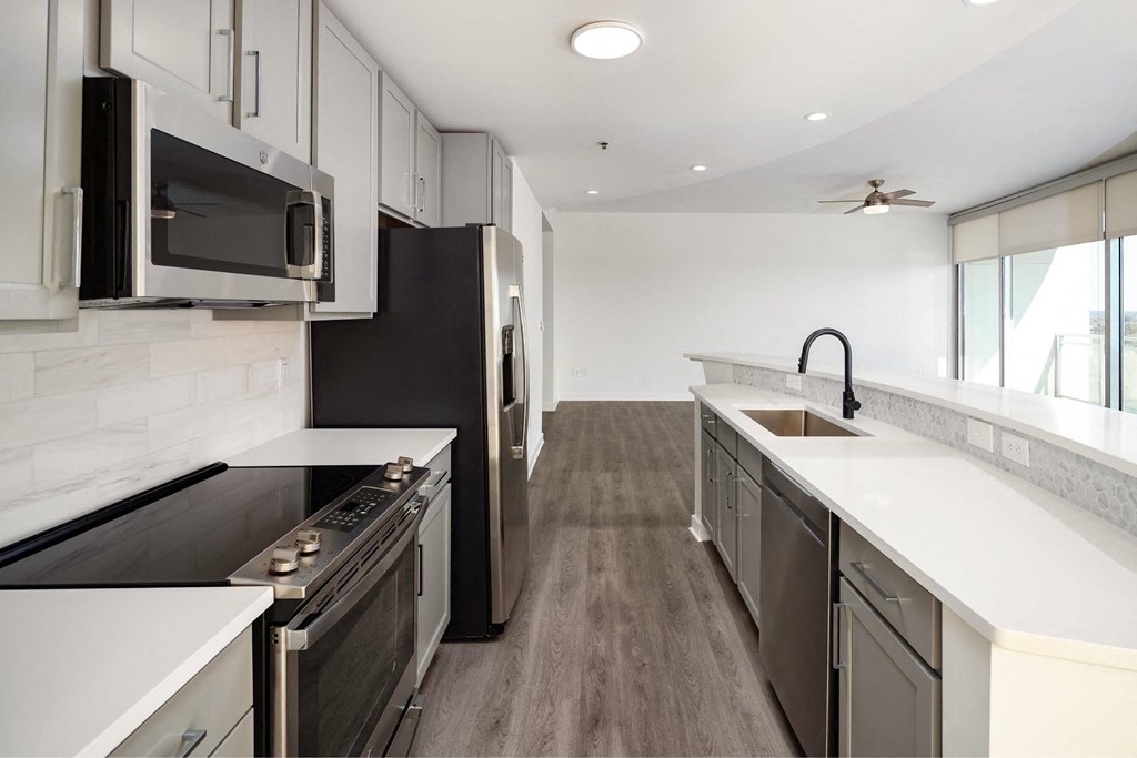 a kitchen with an island and a stove and a microwave