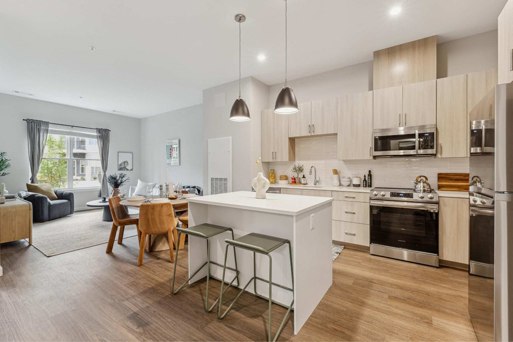 a kitchen and living room with an island and stools