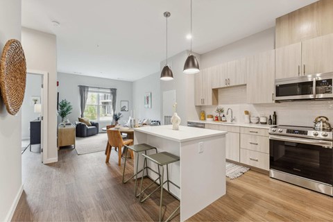 a kitchen and living room with a white counter top