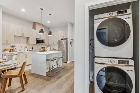a kitchen with a washing machine and a washer and dryer in it