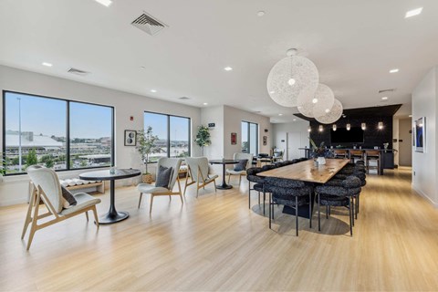 a living room with a table and chairs and a large window