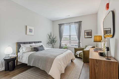 a bedroom with a bed and a window