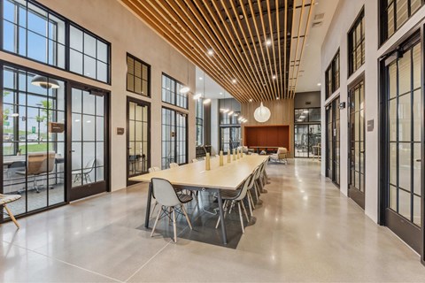 a large conference room with large windows and a long table with chairs