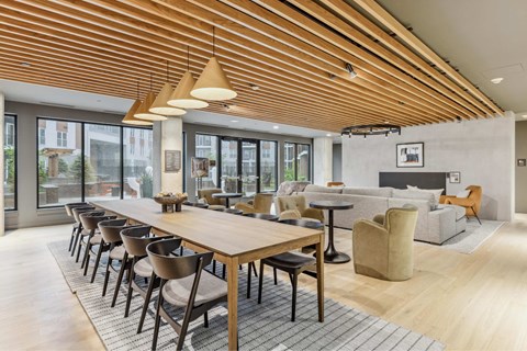 a living room with a long wooden table and chairs
