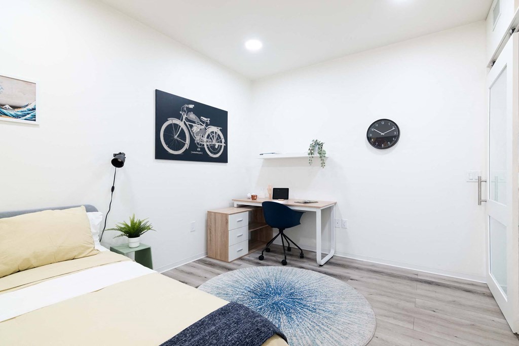 a bedroom with a bed and a desk