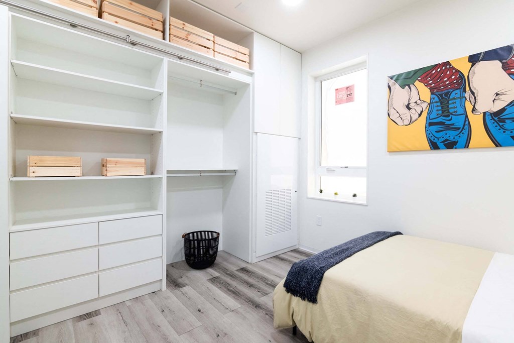 a bedroom with a bed and a closet