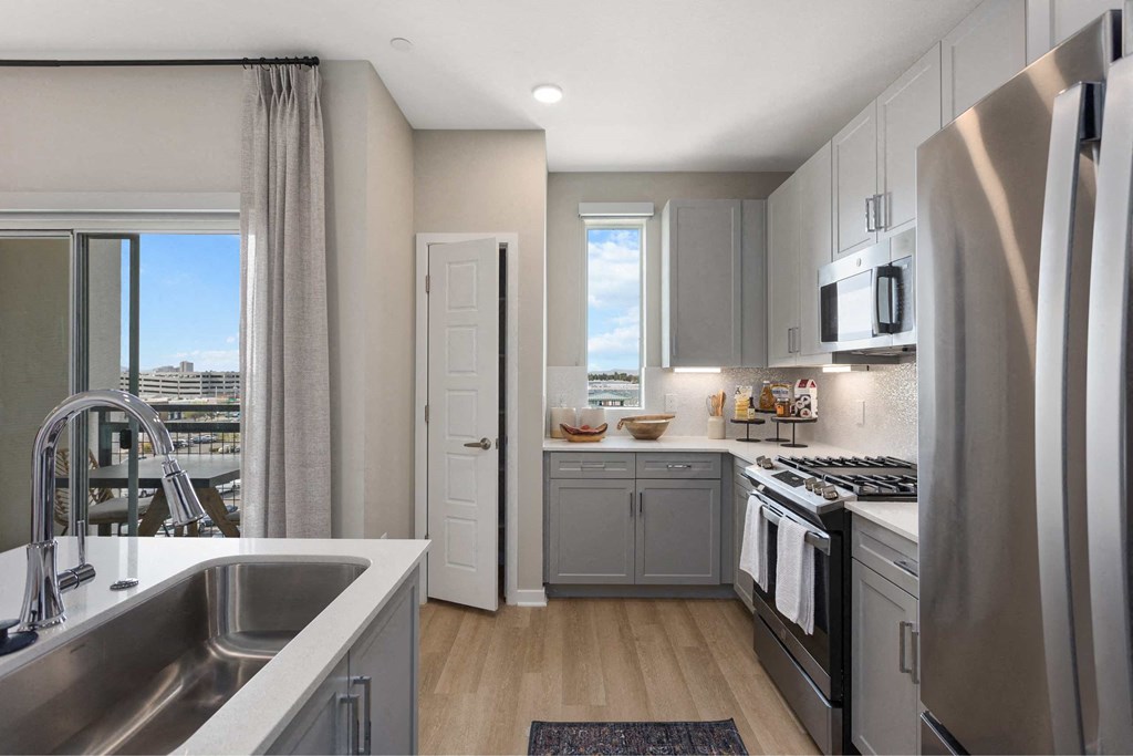 a kitchen with stainless steel appliances and a window