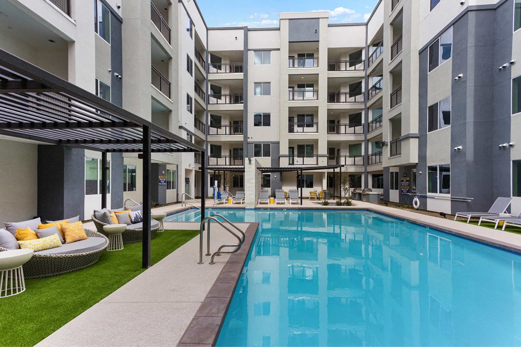 a large swimming pool in front of a building