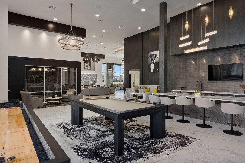 a living room with a pool table in the middle