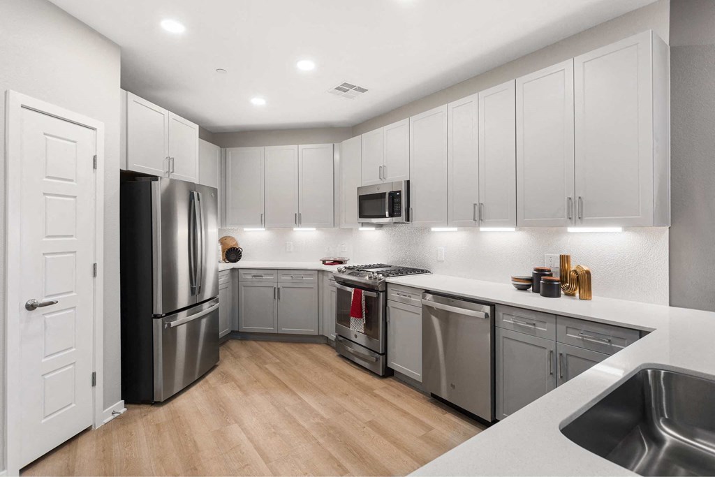 a kitchen with stainless steel appliances and white cabinets